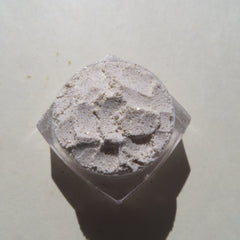 Powdered cosmetic with light beige color, glitter, and clear container
