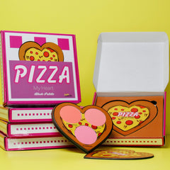Close-up of pizza-shaped blush palette showing four vibrant powder shades in coral, pink, peach, and bronze