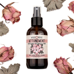 Toner bottle with brown glass, white label, and dried pink flowers around it