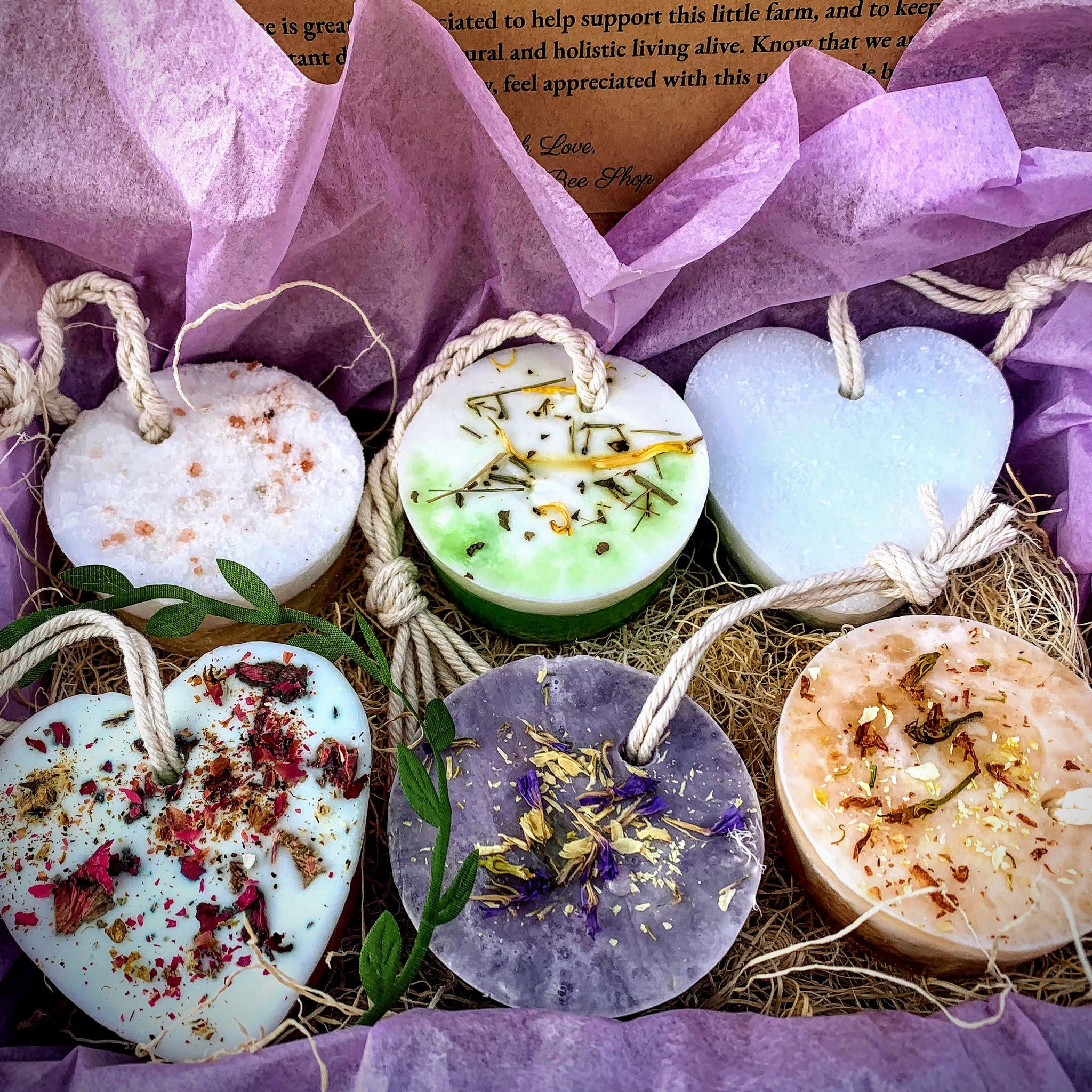 Scented wax melts with heart and round shapes, various colors, and dried flowers, in a gift box