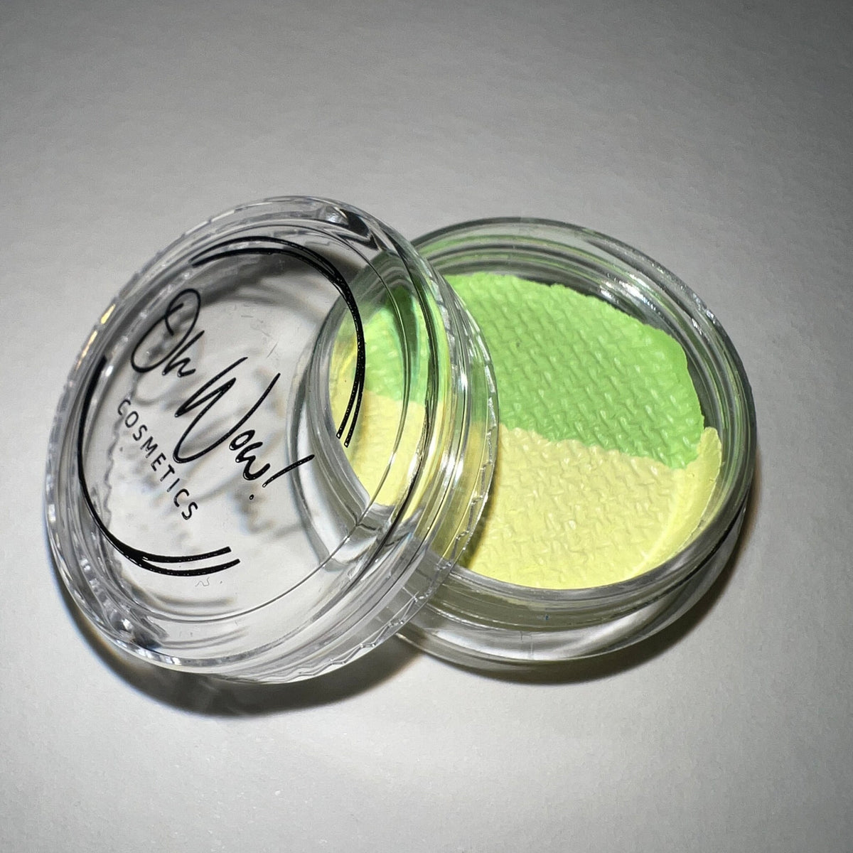 Close-up of Lime Graphic Liner Eye Shadow in vibrant green shade with sleek black packaging and pointed tip applicator