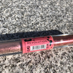 Close-up of Minnie Mouse metallic pink liquid eyeshadow being applied to eyelid with doe-foot applicator
