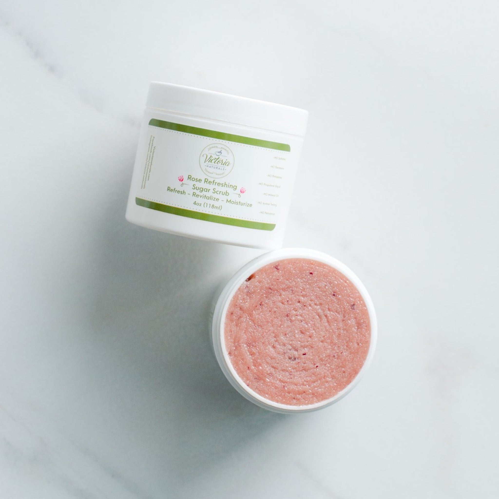 Sugar scrub jar with white container, pink scrub, and Victoria Naturals branding