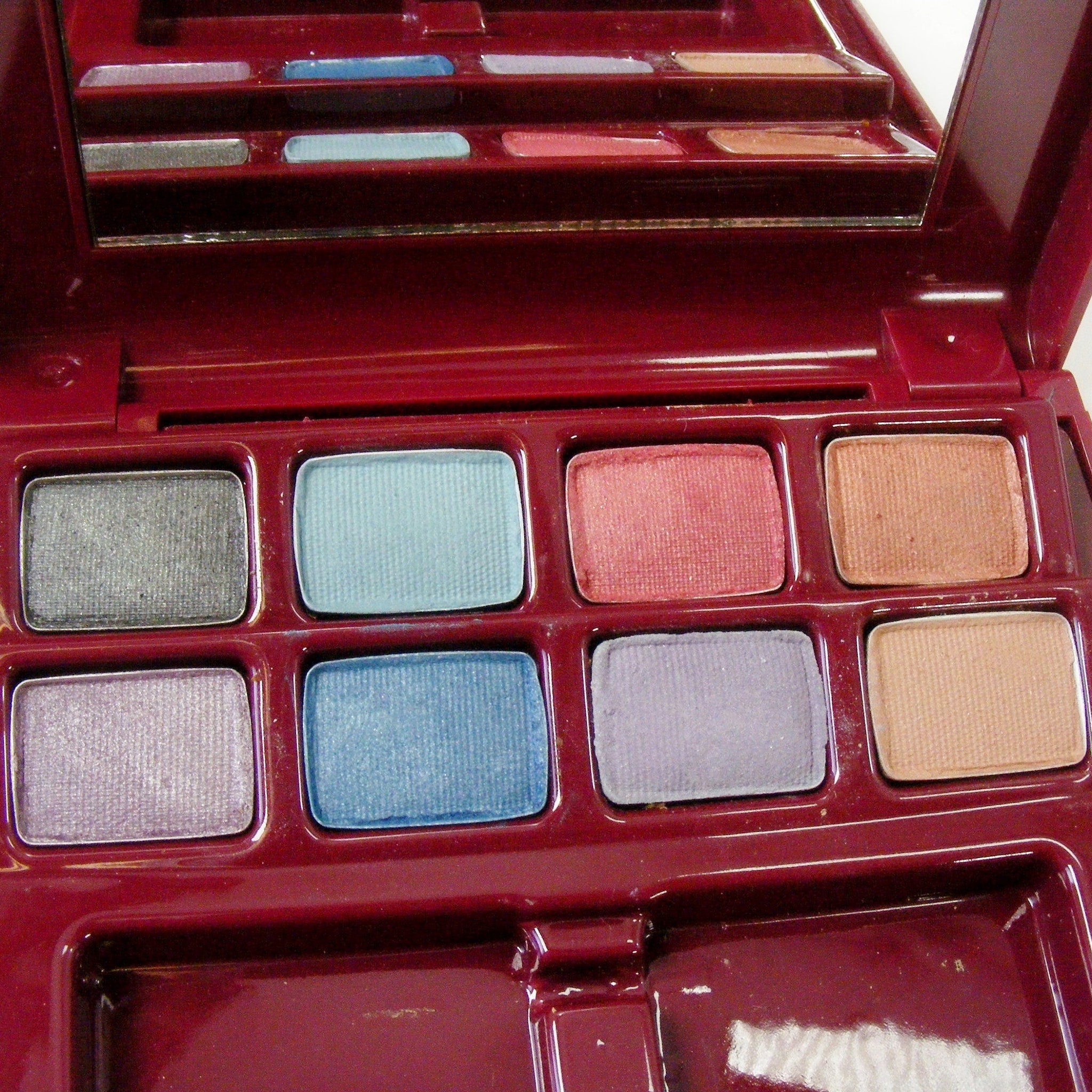 Close-up of Avon Ultra Wear Eye Shadow palette showing four vibrant powder shades with smooth, blendable texture