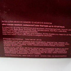 Close-up of fingertips applying shimmering taupe eyeshadow from compact onto eyelid