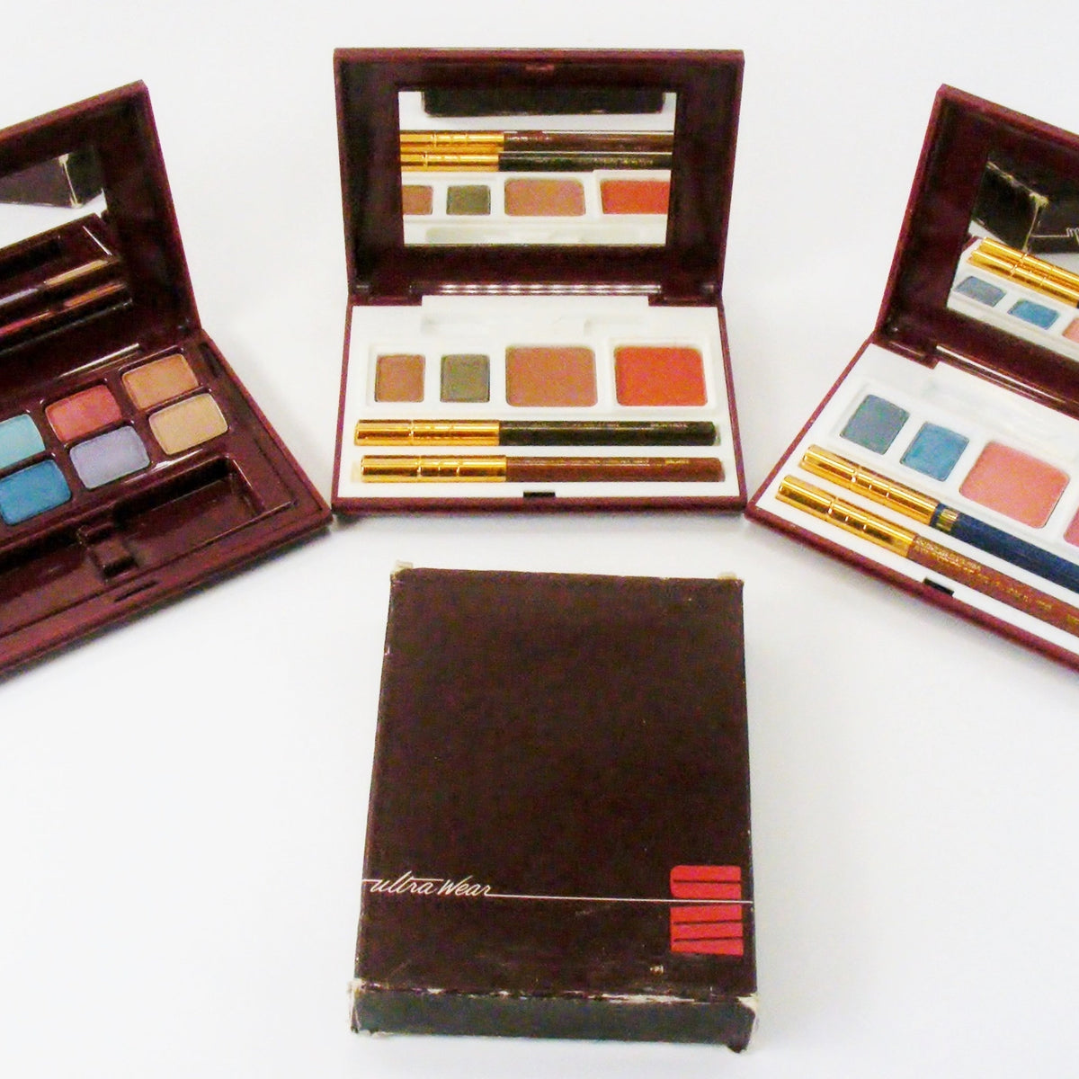 Avon Ultra Wear Eye Shadow palette showcasing six vibrant powder shades in a sleek black compact with silver trim.