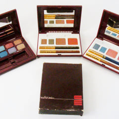Avon Ultra Wear Eye Shadow palette showcasing six vibrant powder shades in a sleek black compact with silver trim.