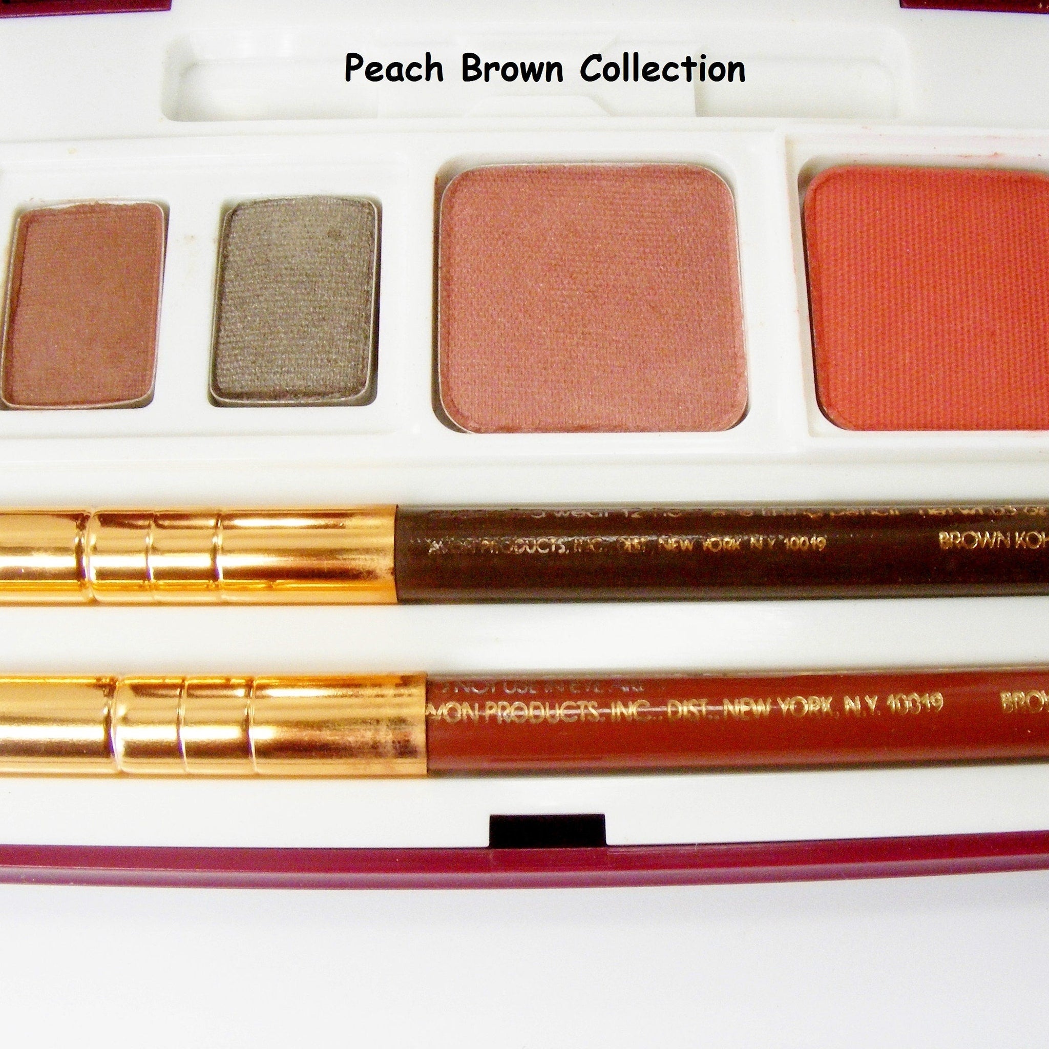 Close-up of multi-shade eyeshadow palette showing rich pigment textures in warm bronze and taupe tones