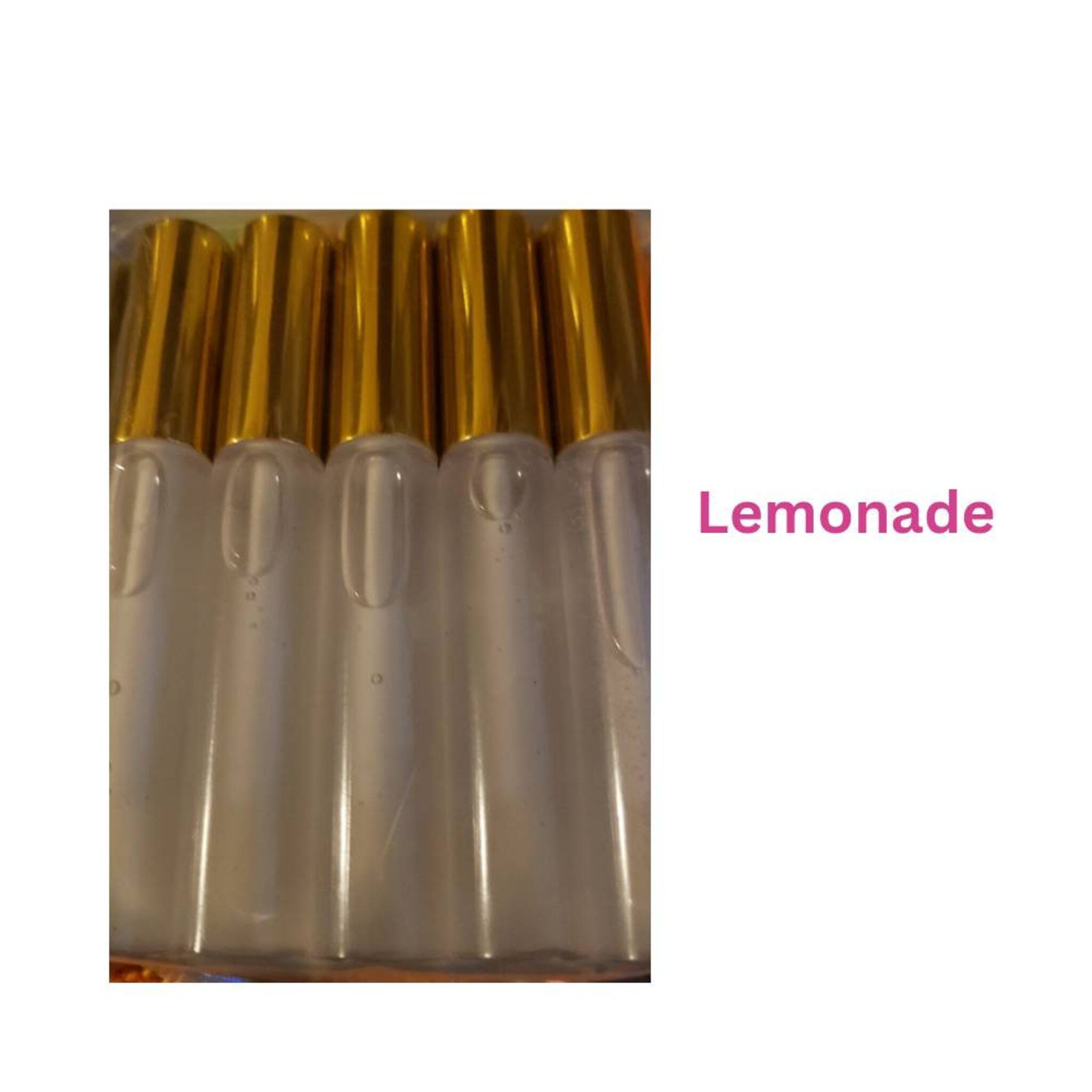 Clear liquid bottles with gold caps, labeled "Lemonade" in pink text