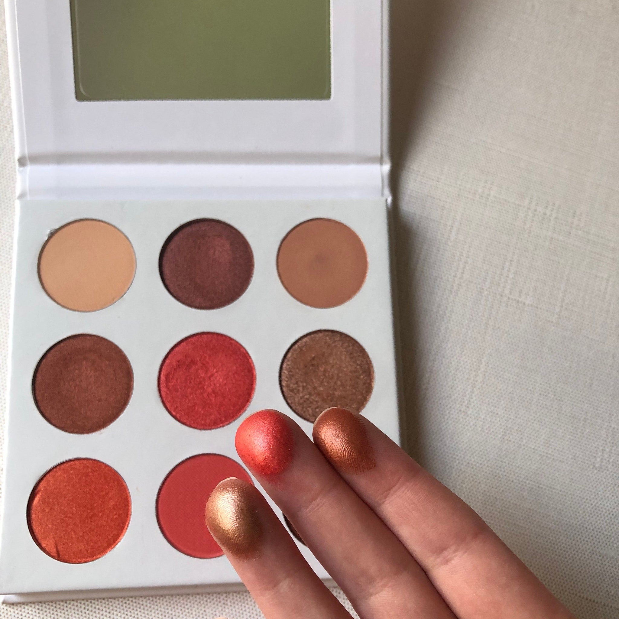 Side view of Red Daisies Eye Shadow Palette showing angled edge with six vibrant matte and shimmer shades