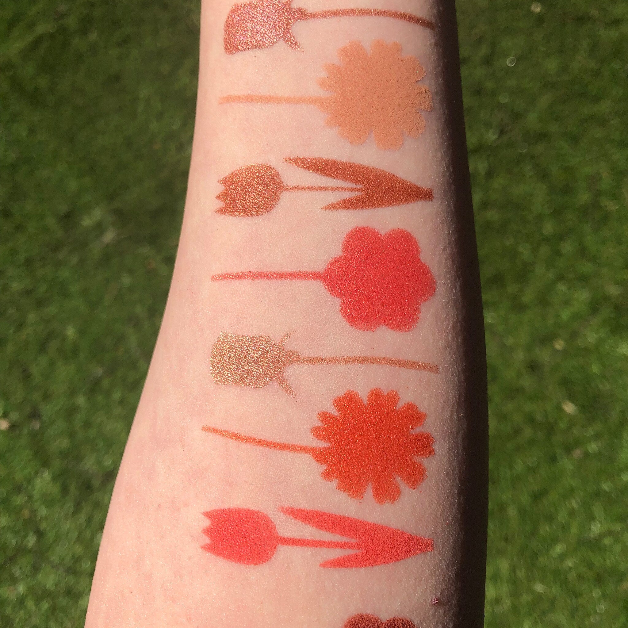 Close-up of Red Daisies Eye Shadow Palette bonus travel mirror inside compact with floral design