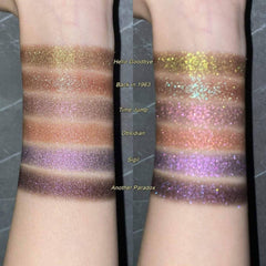 Side angle of pressed purple-olive eyeshadow pan showcasing chameleon shimmer and color shift sparkle