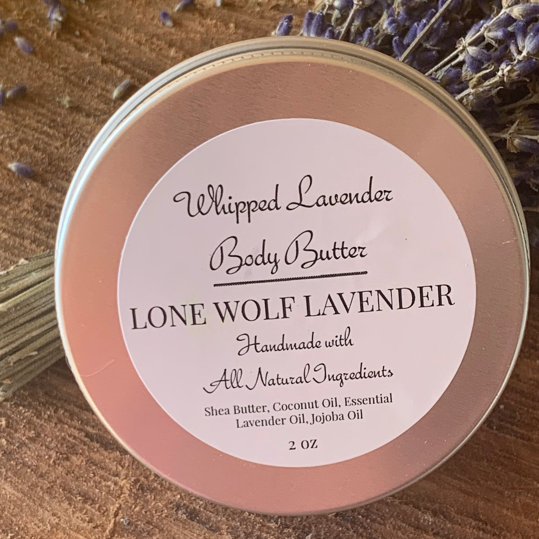 Soft lavender whipped body butter in a sleek white jar with gold lid, shown on a spa tray