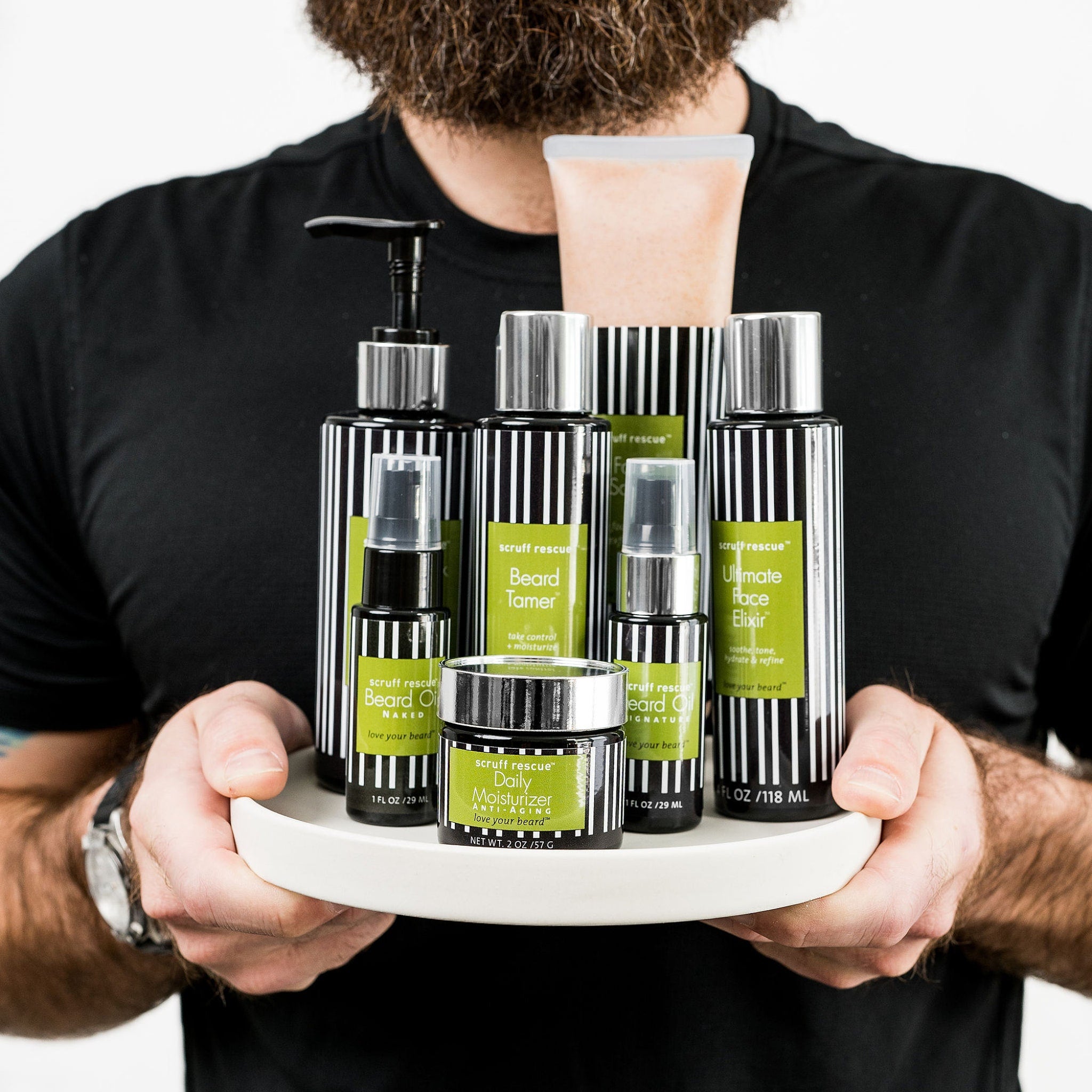 Beard care products with black and white striped bottles, green labels, and a man holding them