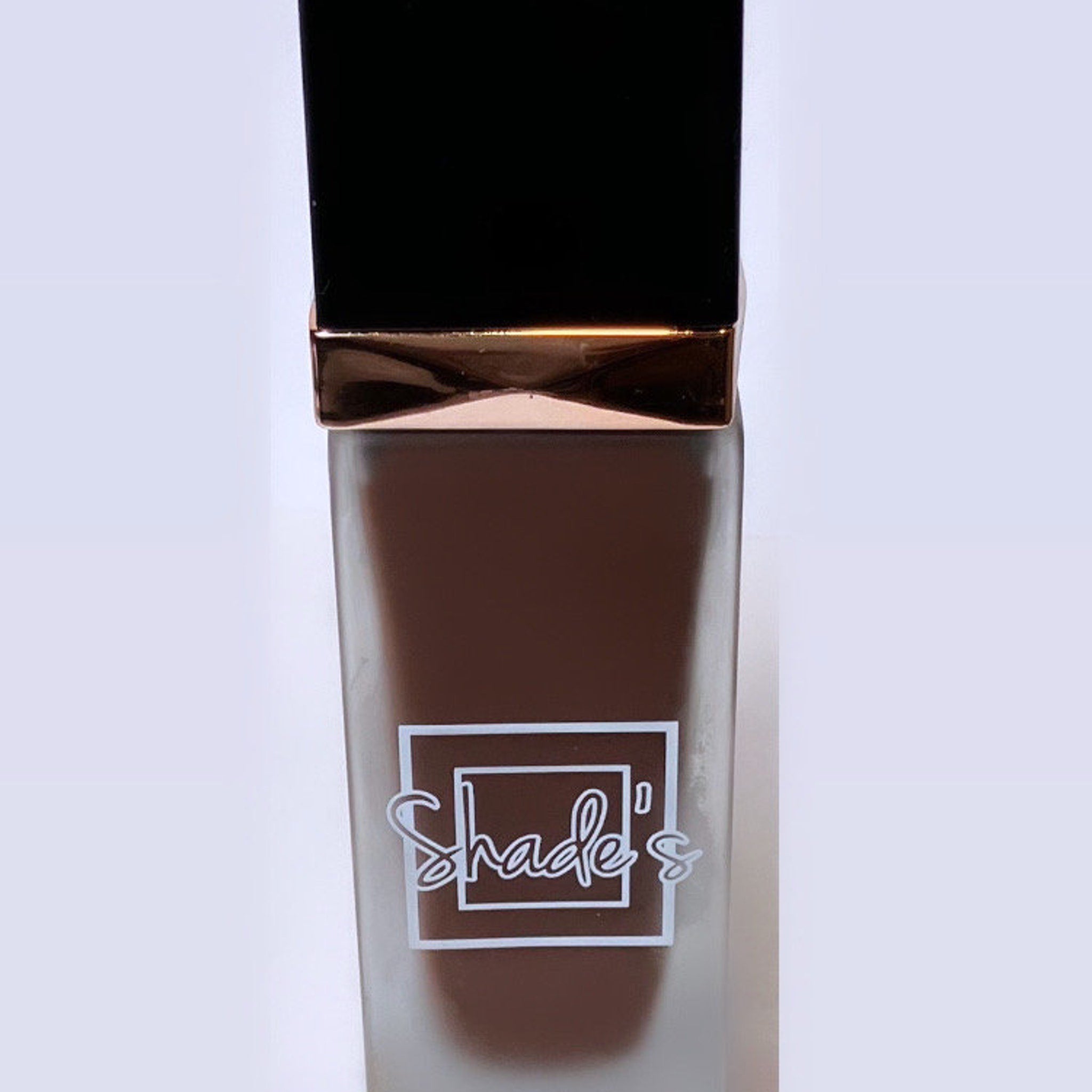 Side view of Shade-Perfect Foundation compact showing sleek black case with angled mirror and shimmering bronze eye shadow pan