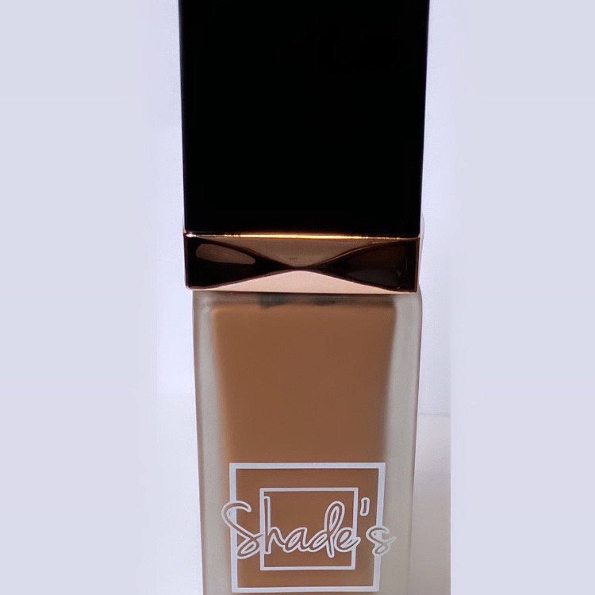 Side view of Shade-Perfect Foundation compact showing sleek black case with mirrored interior and pressed powder pan