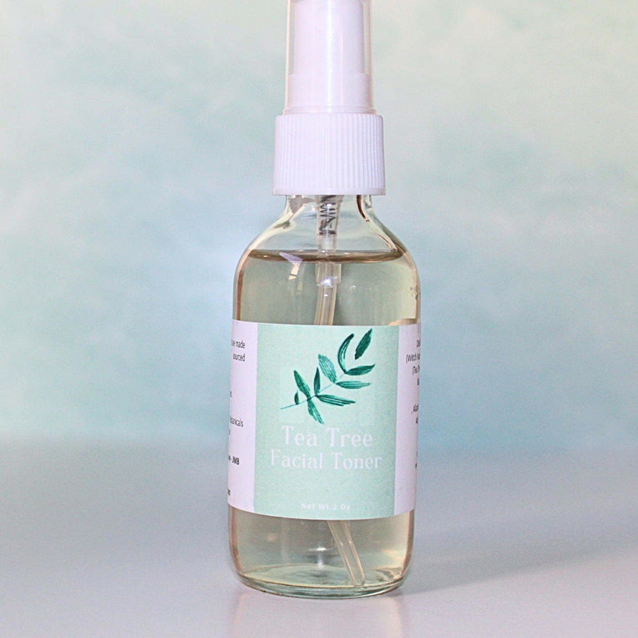 Tea Tree Facial Toner in clear glass bottle with white pump and label