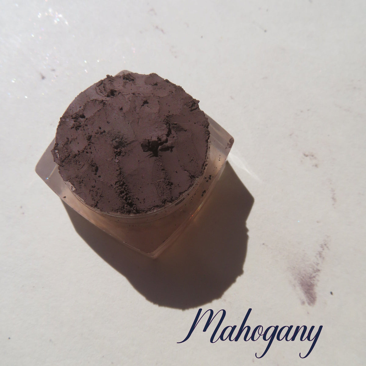 Rich matte mahogany loose mineral eye shadow in dark brown vegan powder form with velvety texture