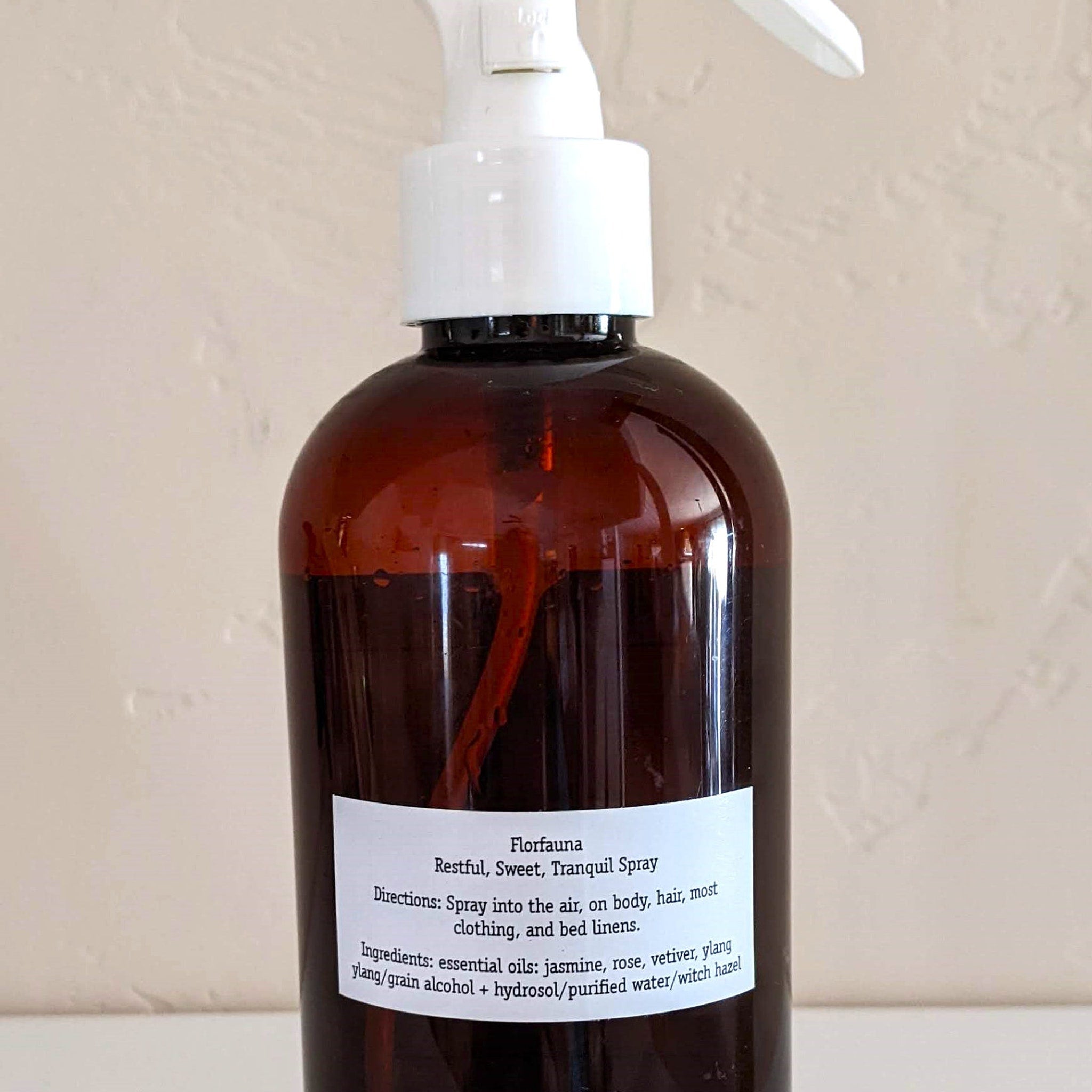Spray bottle with brown glass, white pump, and Florfauna label with text