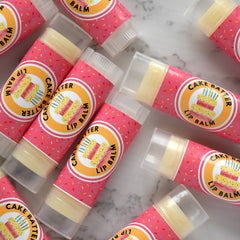 Lip balm tubes with pink sprinkle pattern, clear cap, and "Cake Batter" label text.