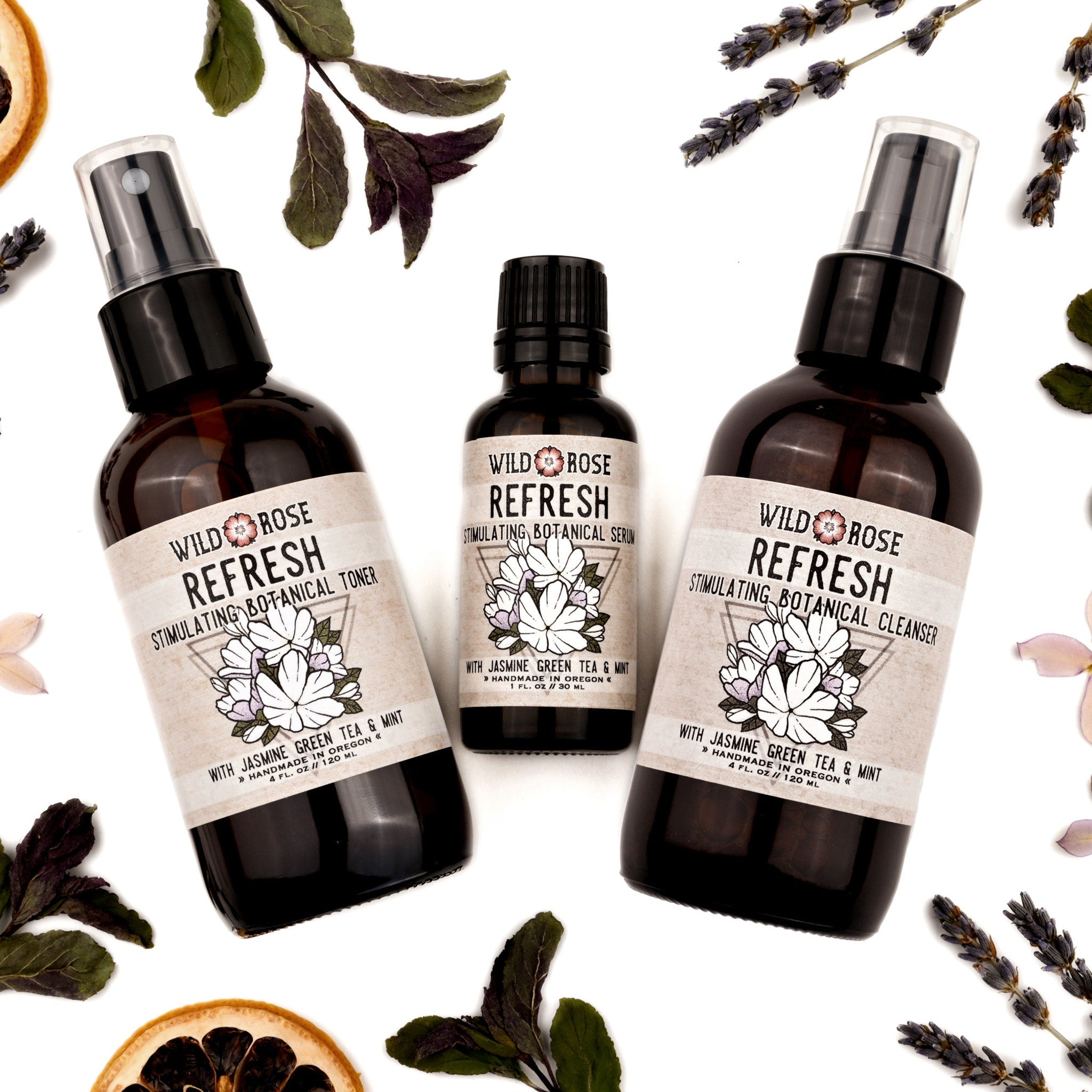 Botanical skincare products with brown glass bottles, white labels, and Wild Rose branding