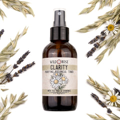 Toner bottle with brown glass, black spray top, and Wild Rose label with flowers surrounded by dried flowers and herbs