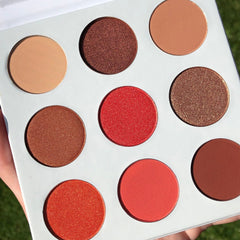 Side view of Red Daisies Eye Shadow Palette showing six vibrant matte and shimmer shades in circular pans with floral imprint.