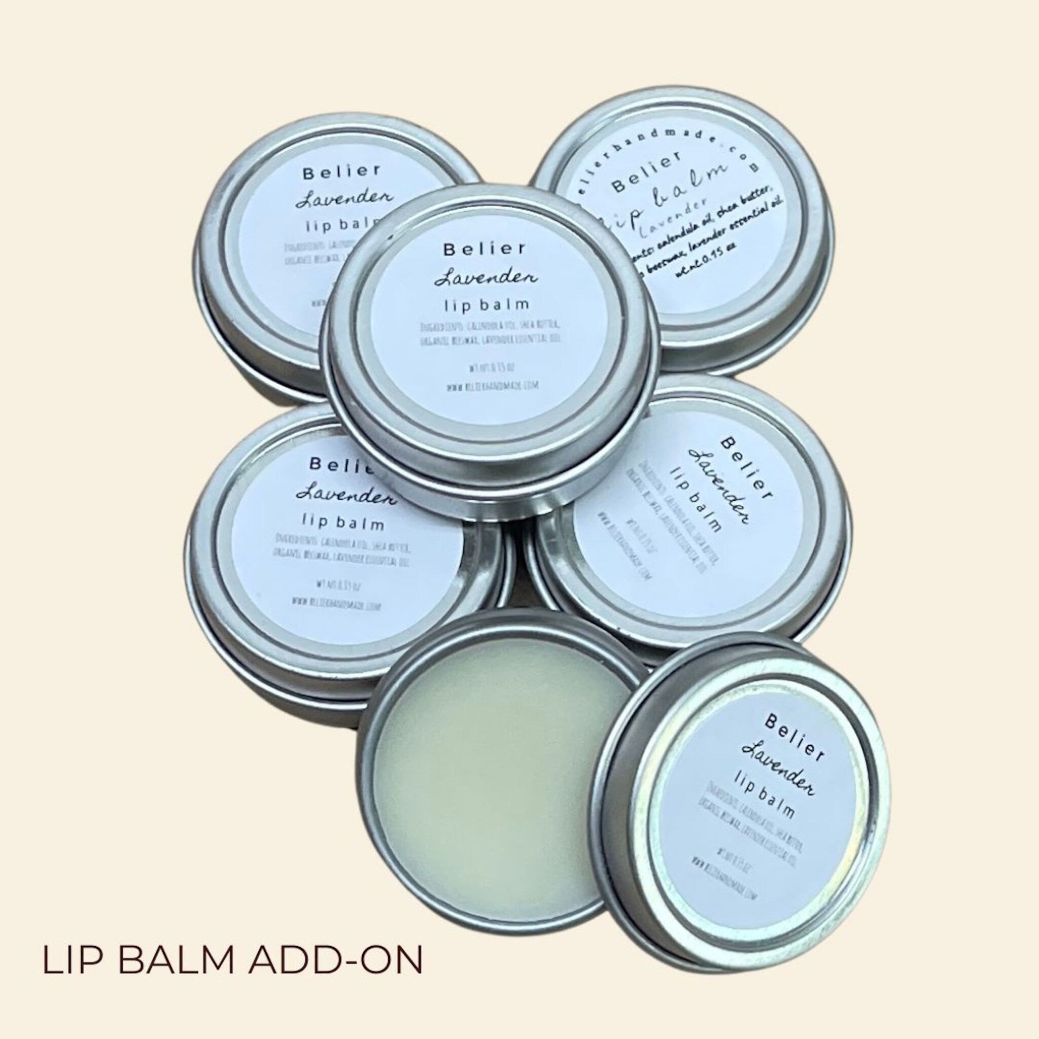 Lip balm tins with Belier Lavender labels, silver metal containers, and visible balm inside