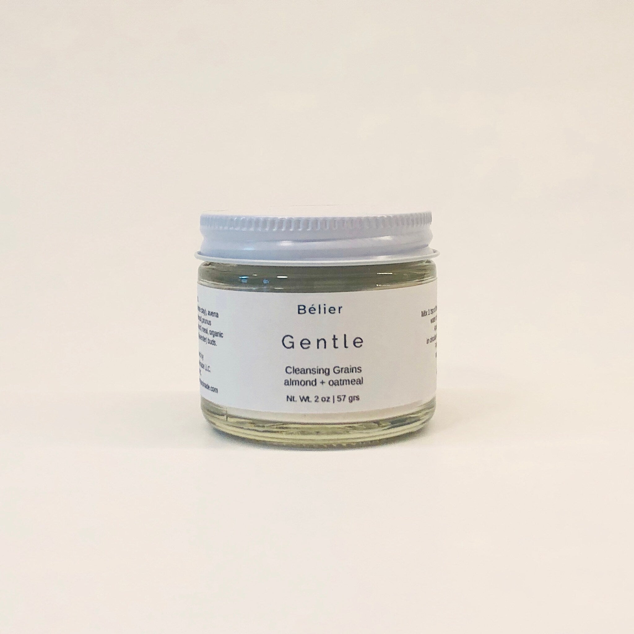Cleansing grains jar with white lid, clear glass, and white label with text