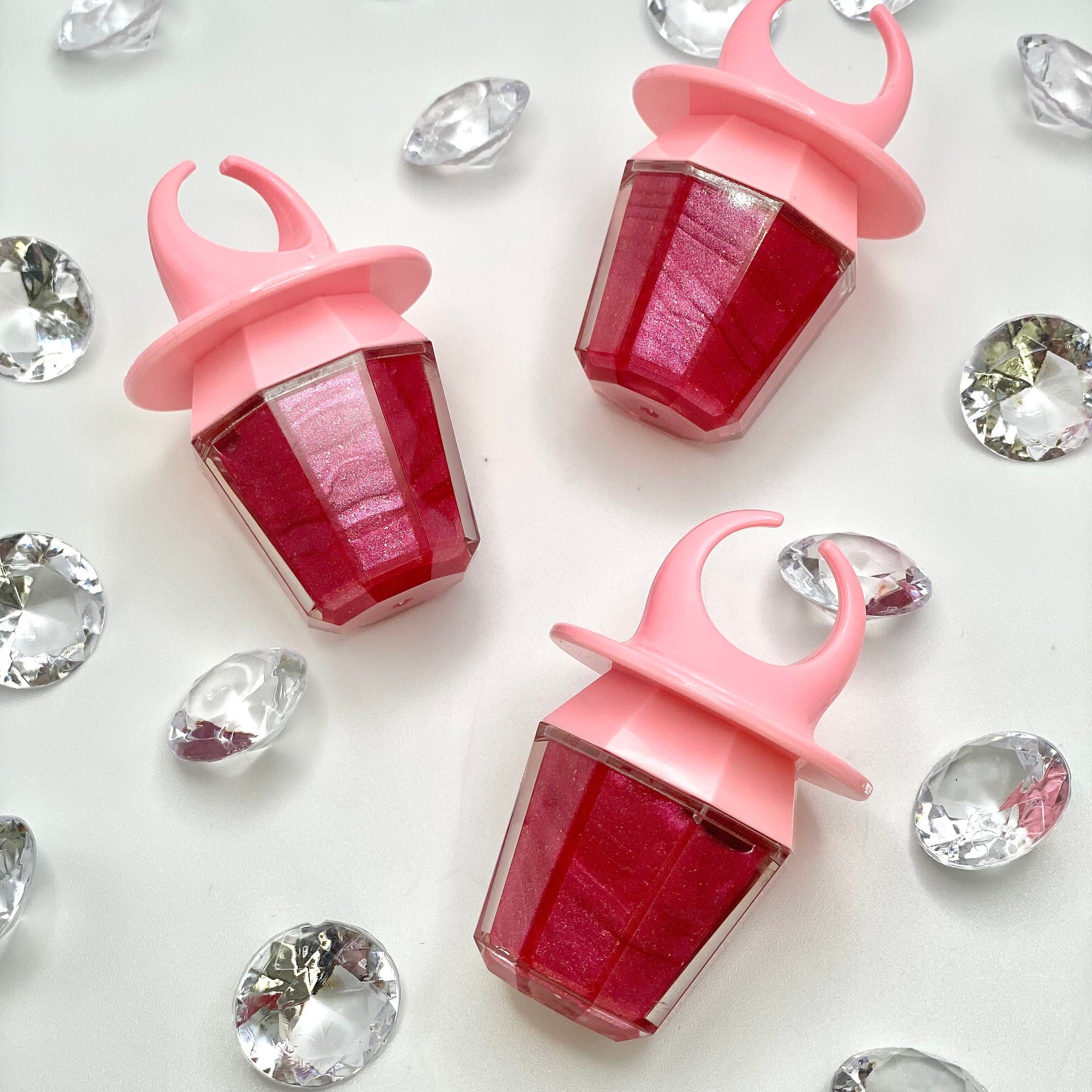 Ring Pop lip gloss in pink and red with diamond accents