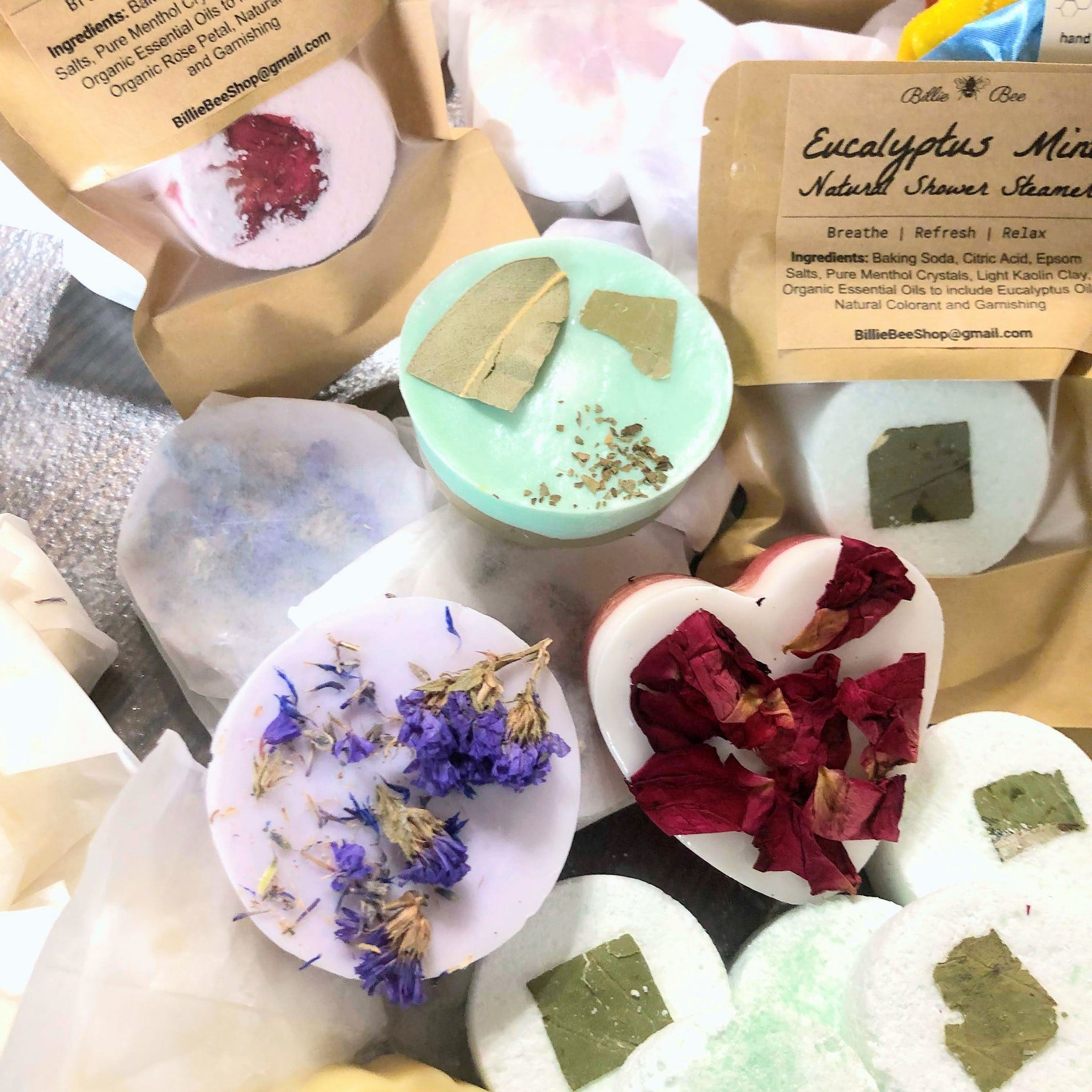 Shower steamers with white, green, and purple colors, decorated with leaves and petals, Billie Bee Products brand