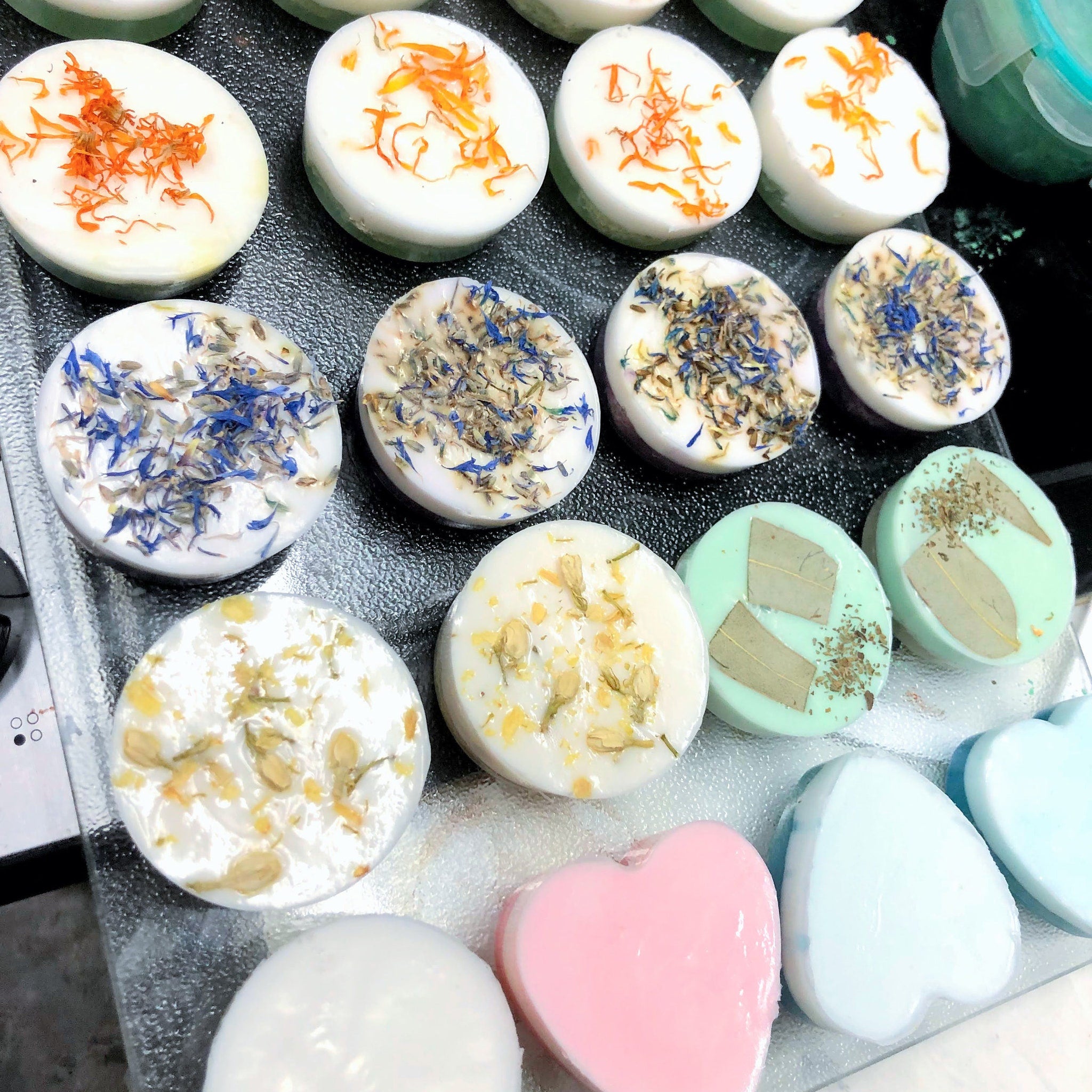 Soap bars white with orange, blue, and yellow floral accents on display