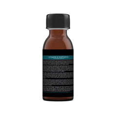 Close-up of golden vitamin E serum with dropper, showcasing its smooth, luminous texture against clean skin.