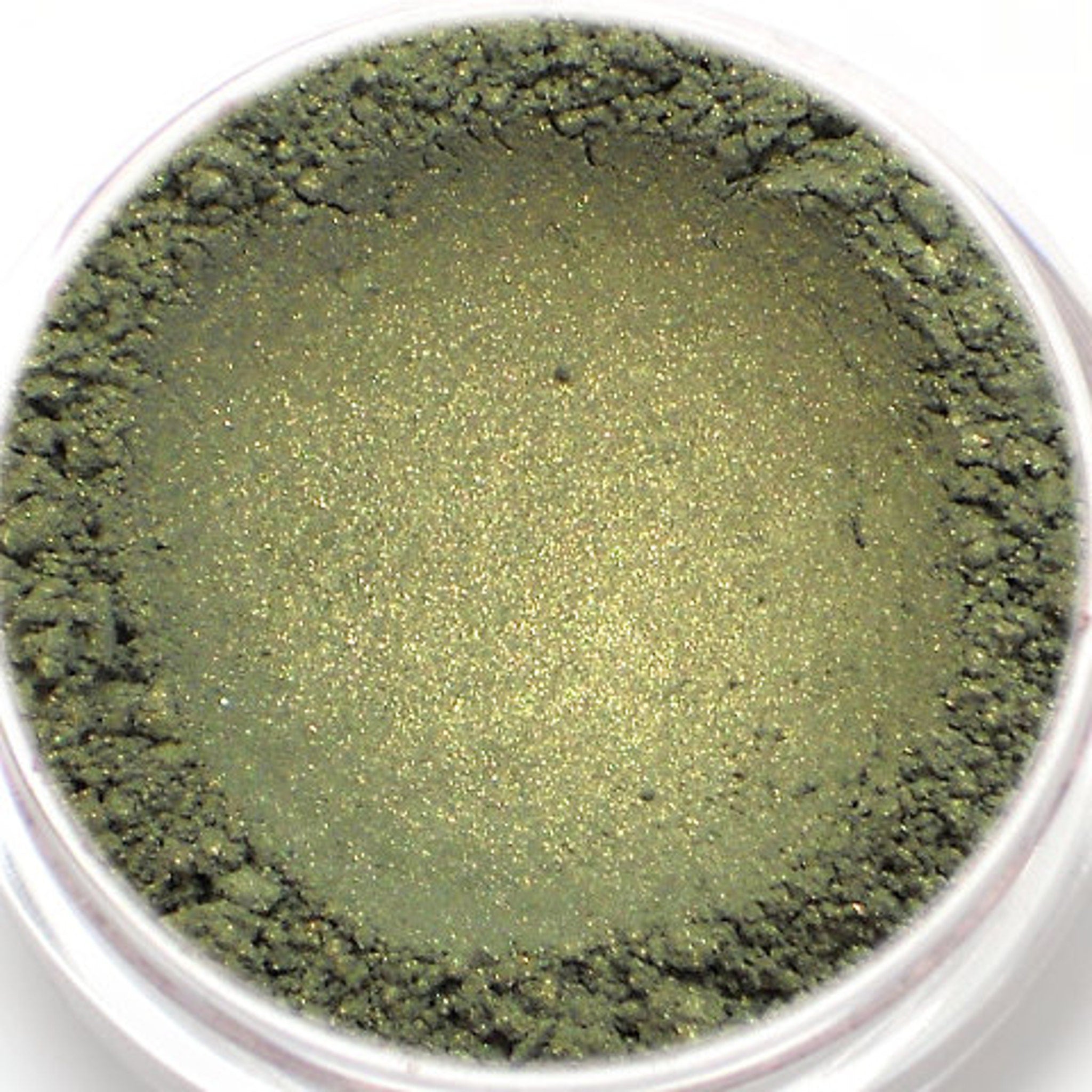 Green eyeshadow powder with shimmer and textured finish in a clear container