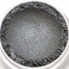 Close-up of dark metallic silver vegan eyeshadow with shimmering mineral pigment in compact case
