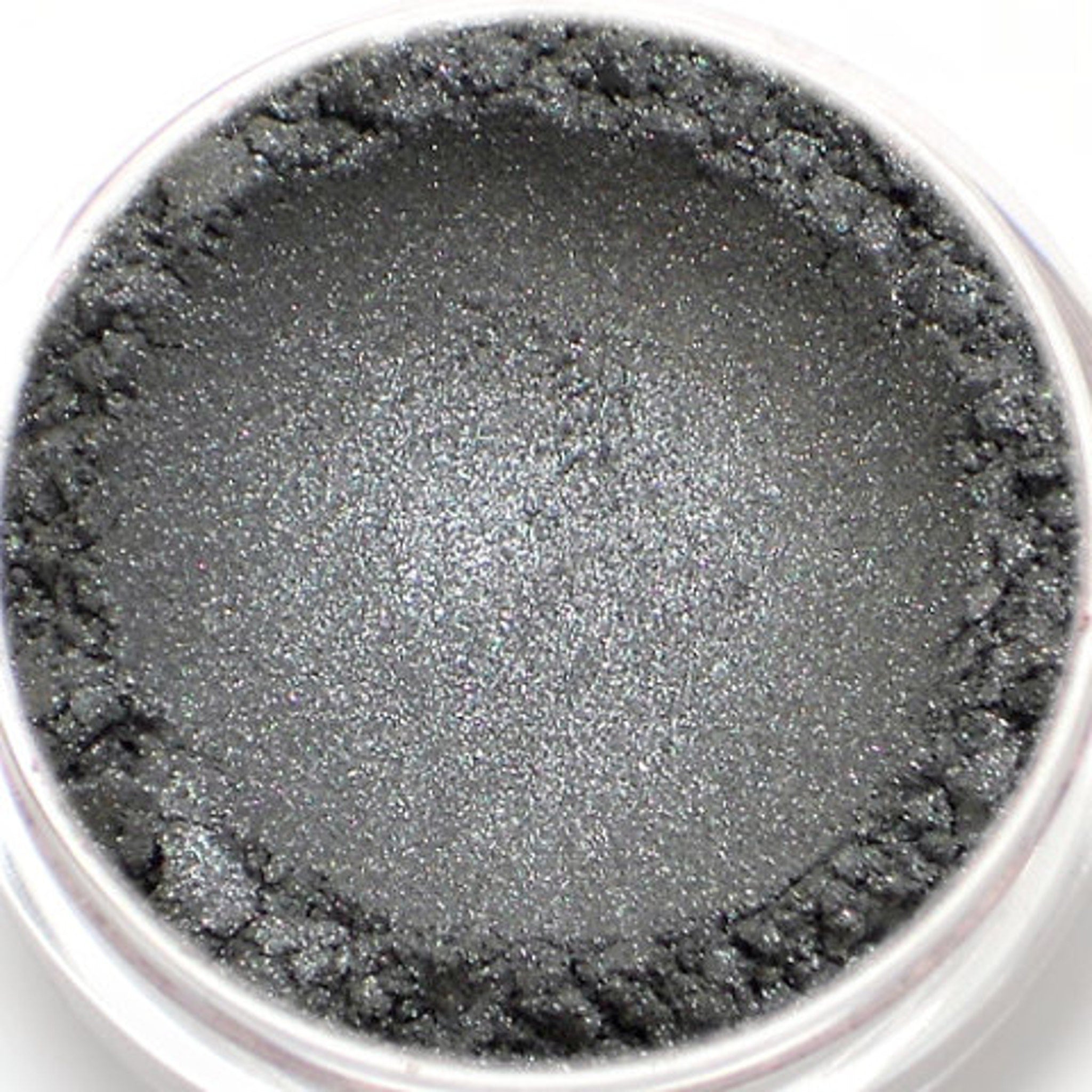 Eyeshadow powder in gray with shimmer and textured edge in a clear jar