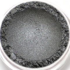 Eyeshadow powder in gray with shimmer and textured edge in a clear jar