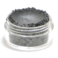 Side view of dark metallic silver vegan eyeshadow pot showing reflective pigment texture