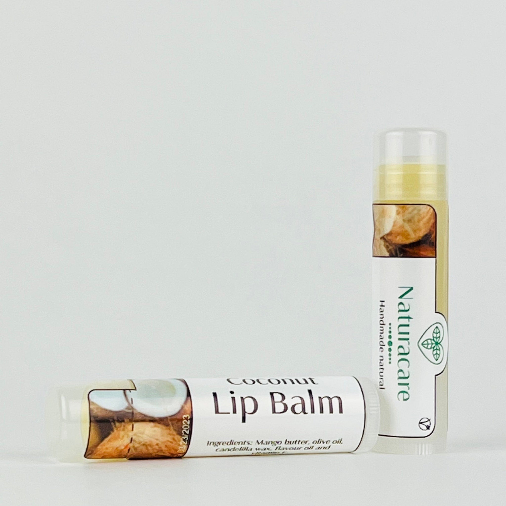 Lip balm tubes with white and brown labels, Naturacare branding, and coconut illustration