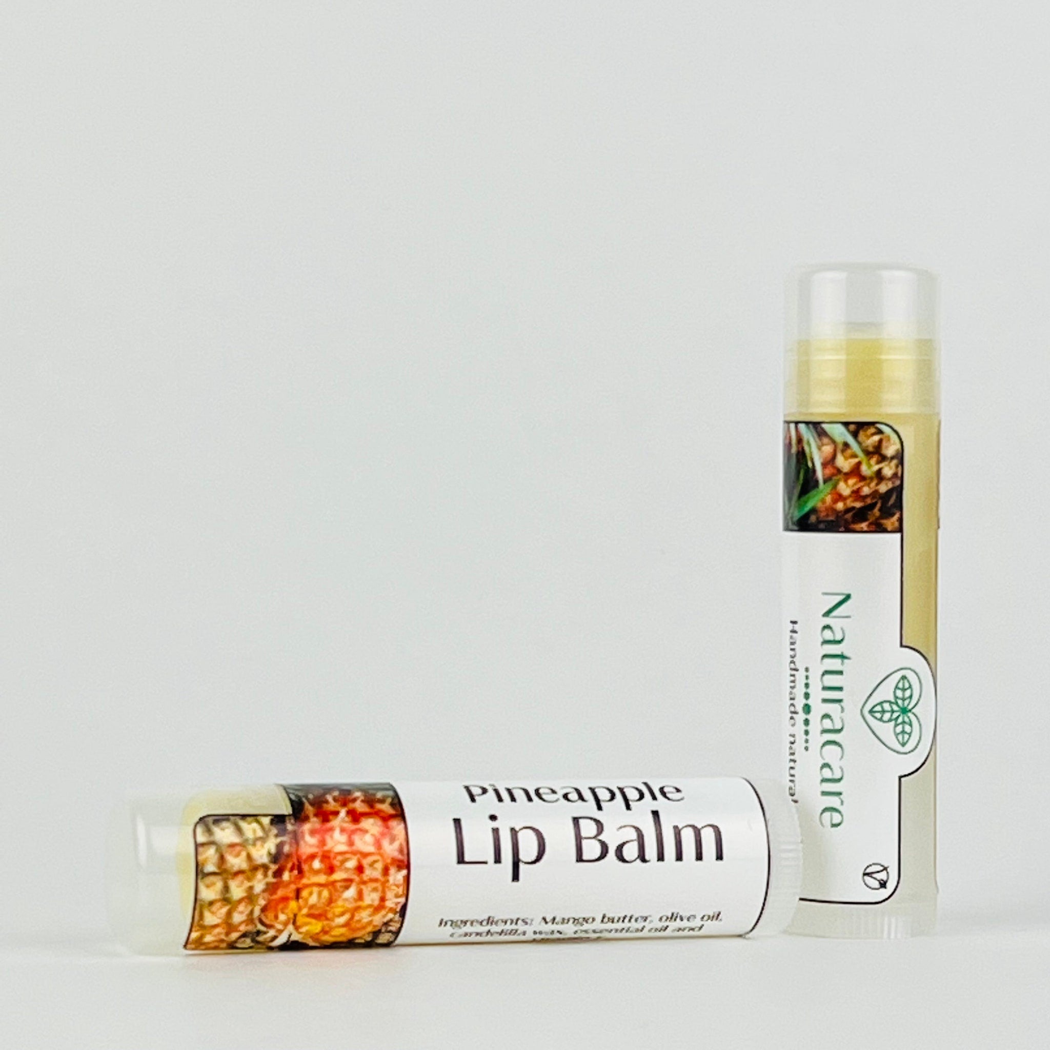 Lip balm tubes with clear, white, and tan packaging, "Pineapple Lip Balm" label, Naturacare brand