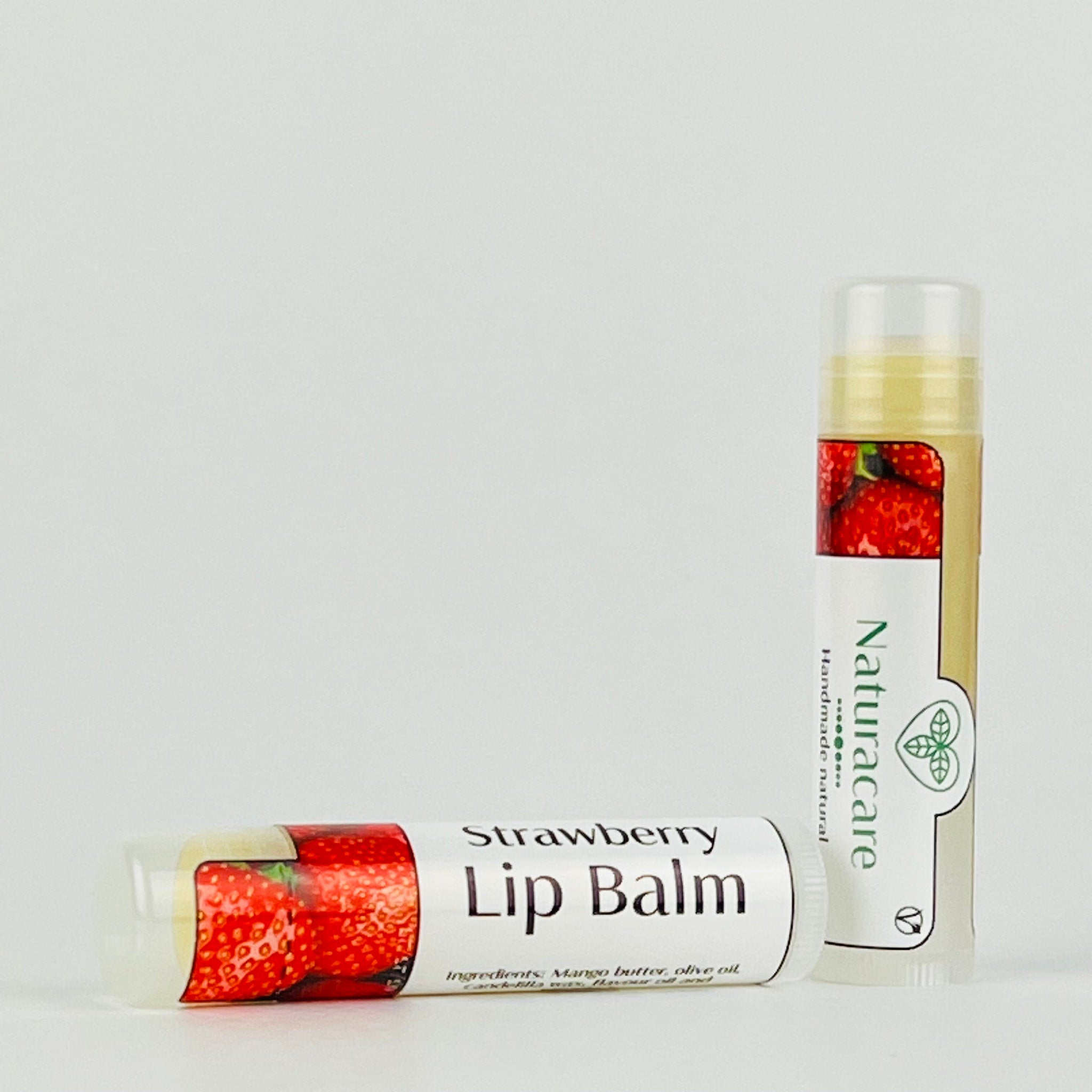 Strawberry lip balm with red strawberry design, white label, and Naturacare branding