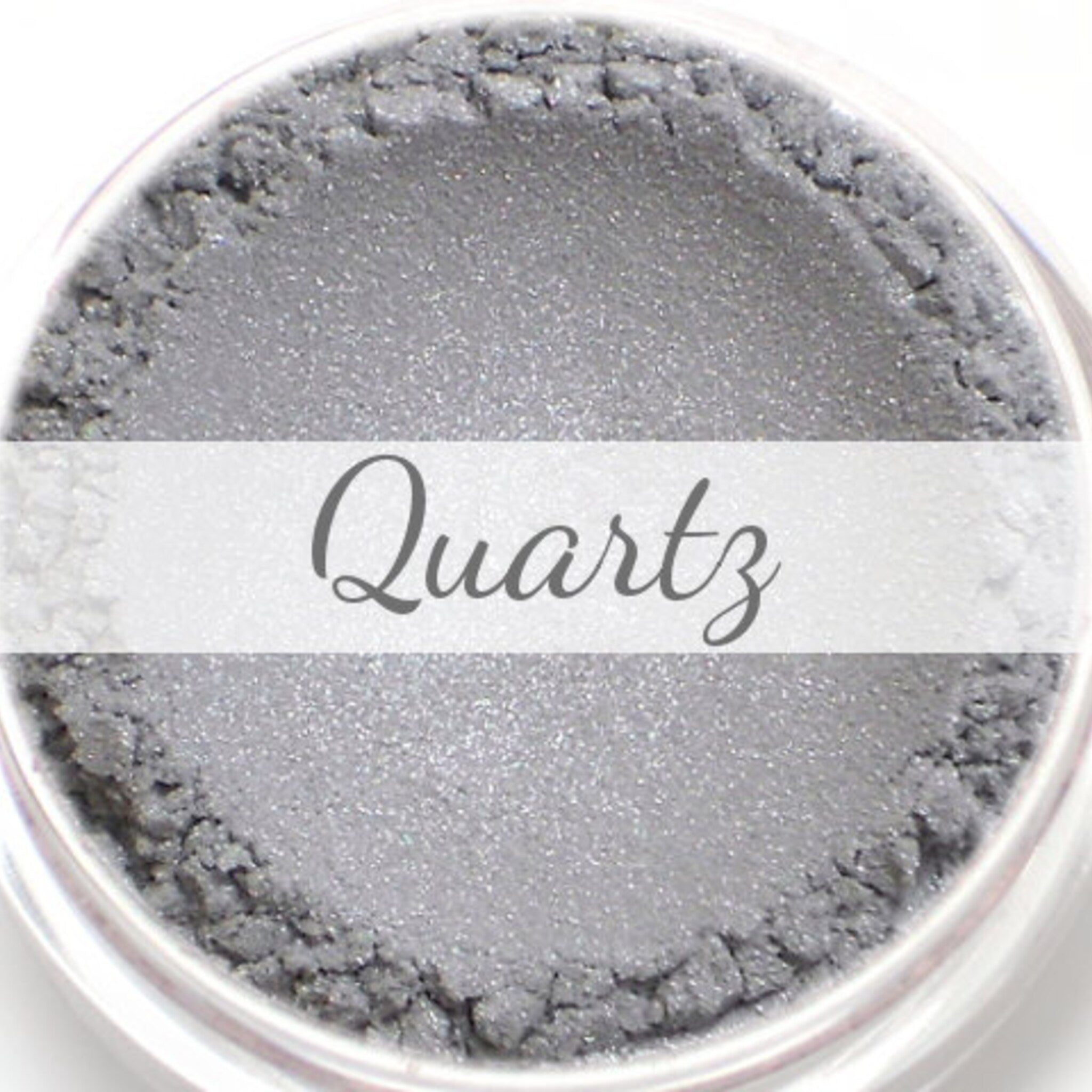 Mineral eyeshadow sample with light silver color, textured finish, and "Quartz" text