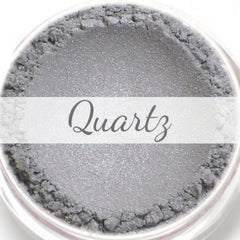 Mineral eyeshadow sample with light silver color, textured finish, and "Quartz" text
