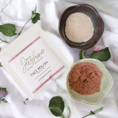 Face Polish with Wild Jasmine branding, white packet, pink accents, and brown powder in a bowl