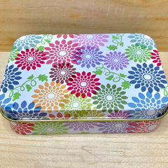 Tin box with floral pattern, colorful flowers, and gold trim detail