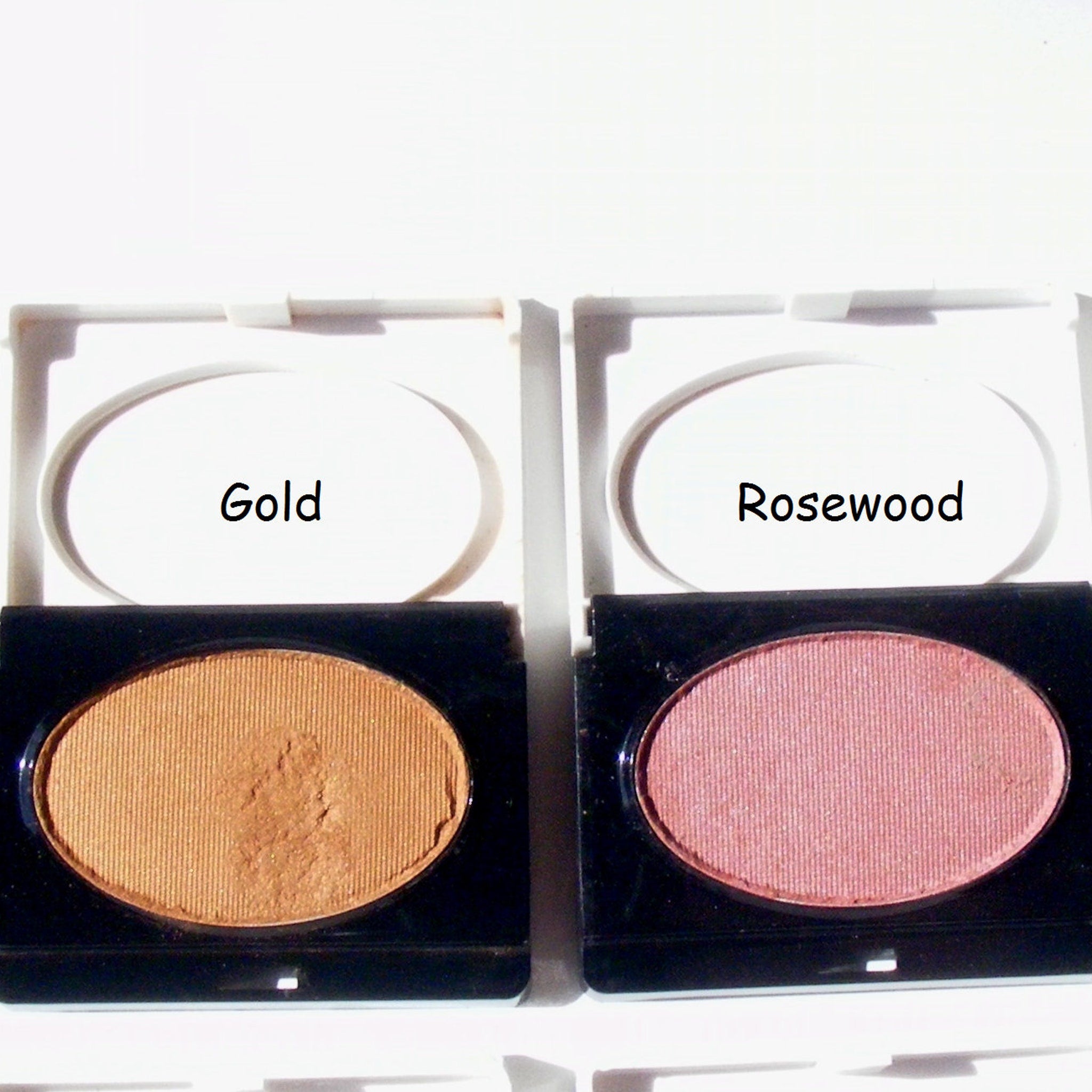 Avon eyeshadow compacts, gold and rosewood colors, with ribbed texture