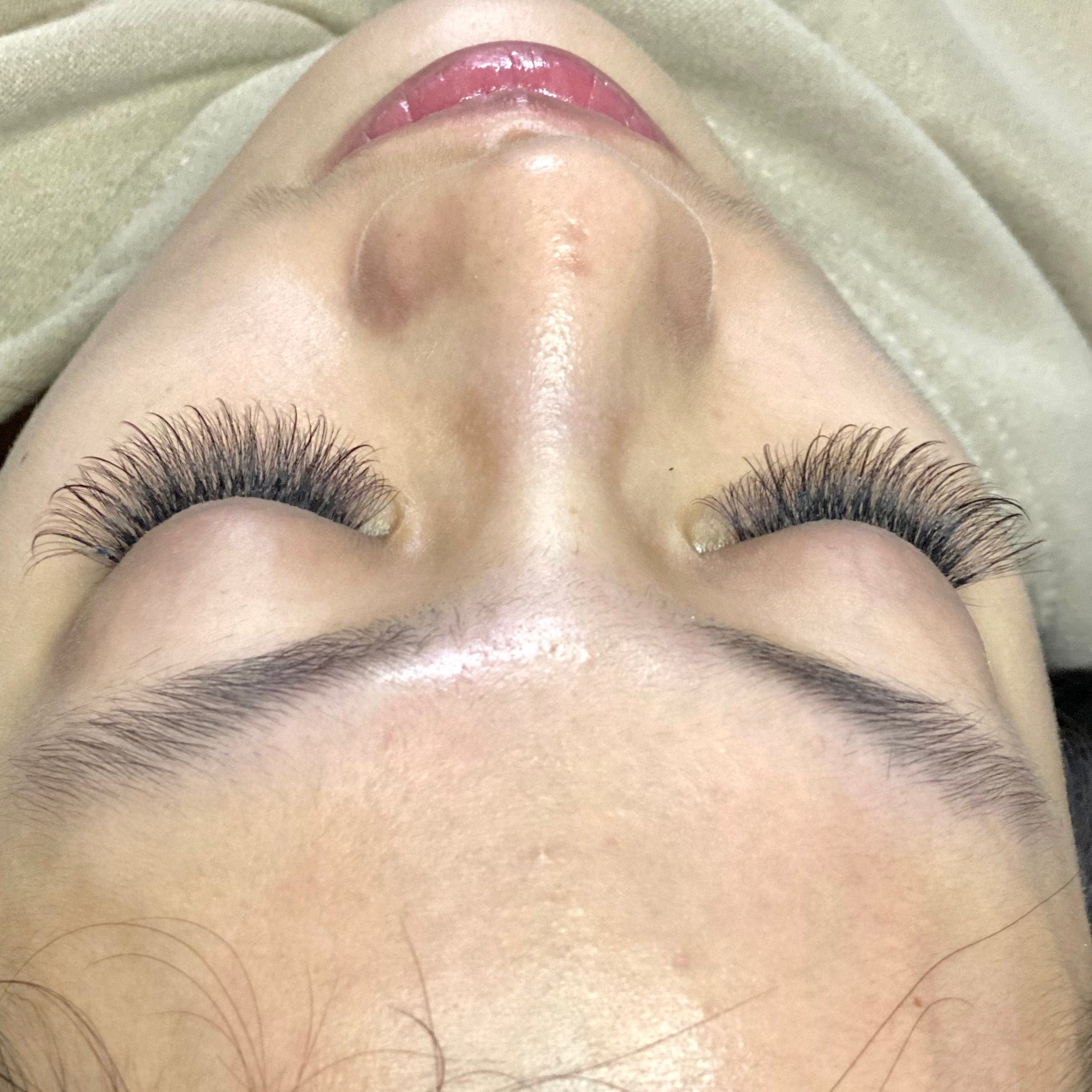 Eyelash extensions with dark black lashes and light skin tone, close up view