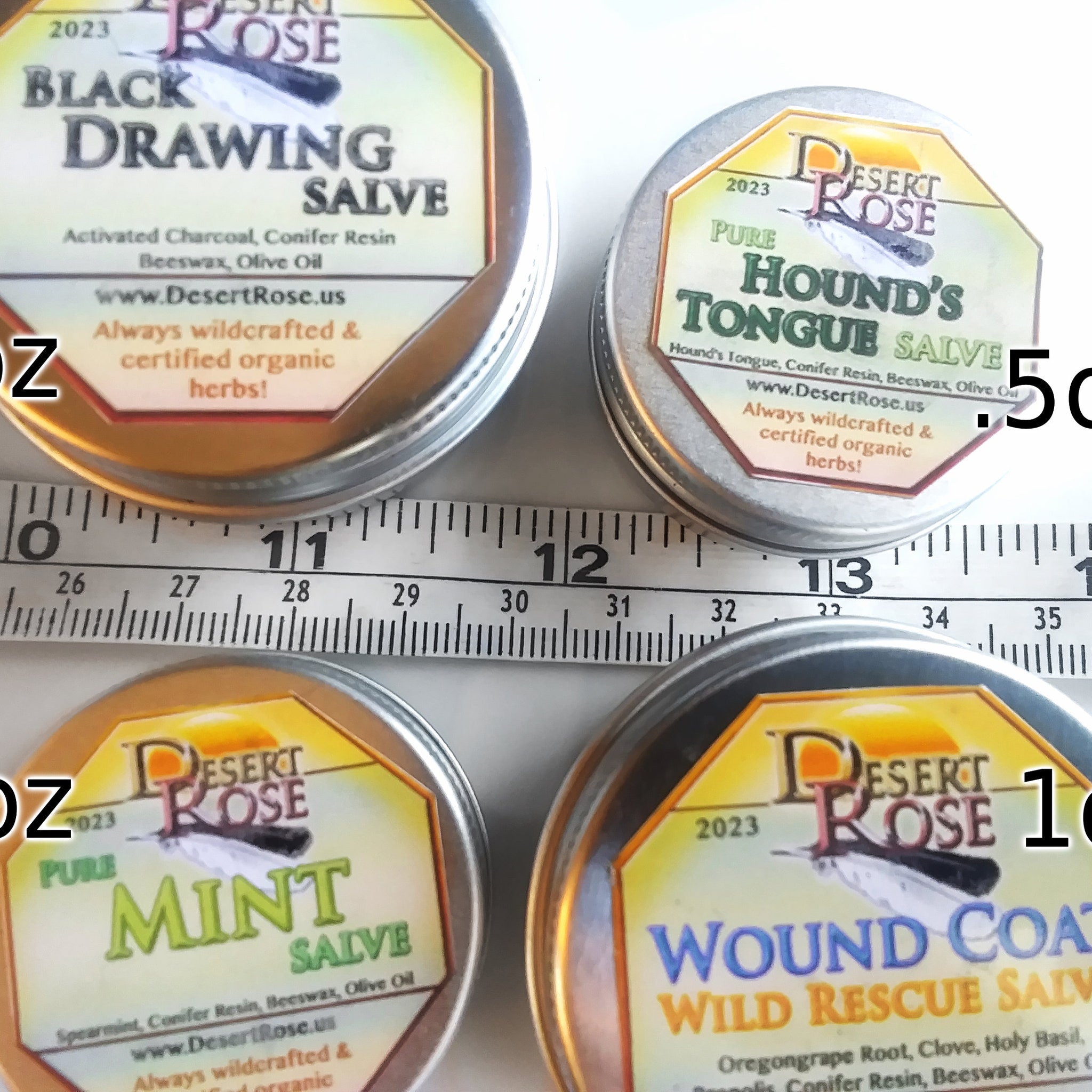 Salve tins with Desert Rose labels, silver metal, yellow and brown label, various herbal formulas
