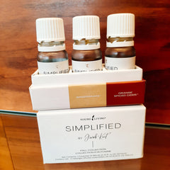 Essential oil bottles with white caps and brown glass, in a white box, Young Living Simplified brand
