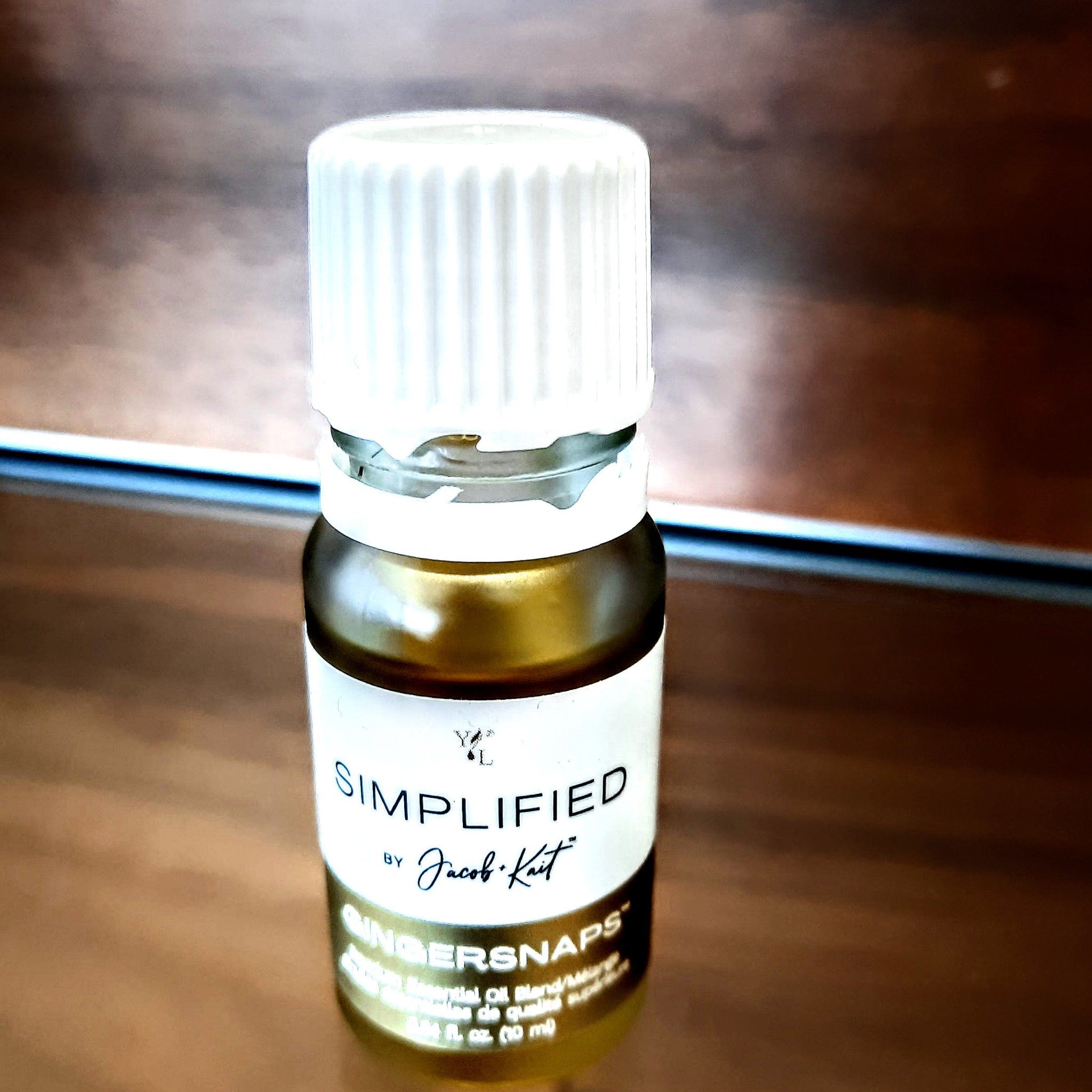 Essential oil bottle with white cap, brown glass, and brand label "Simplified